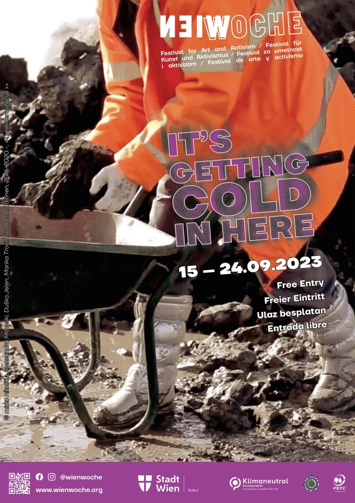 WIENWOCHE 2023: Key image <<remineralizacija>> A figure in working clothes, orange jacket and silver working boots holding a mineral and bending onto a work cart. In the background a pile of ores. ©  mirko nikolić and Aleksandra Mitovski, Duško Jelen, Marika Troili, Tuomas A. Laitinen <<remineralizacija>> is collaborative performance by mirko nikolić and Aleksandra Mitovski, Duško Jelen, Marika Troili, Tuomas A. Laitinen